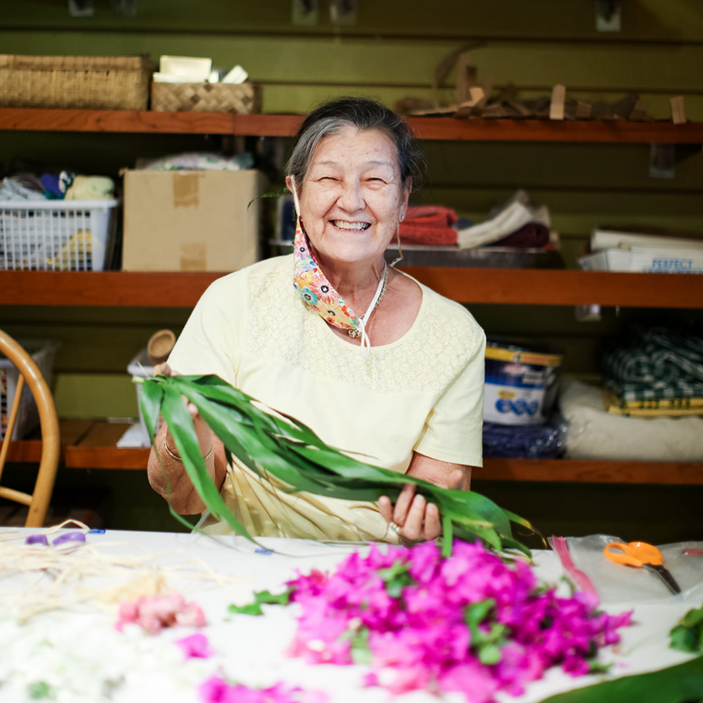 woman smiling holding flower for workshop