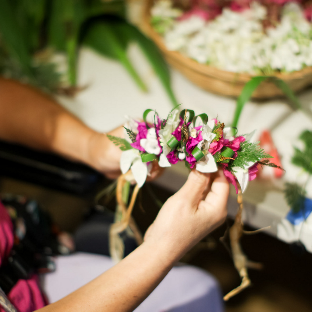 hands holding flower lei