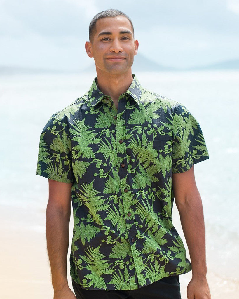 man in green fern shirt on beach