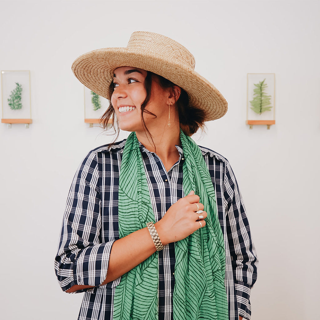 girl in palaka dress and papale hat smiling